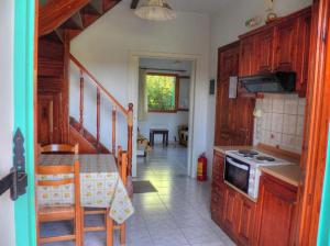 a kitchen with a table and a stove top oven at Villa Marina in Ipsos