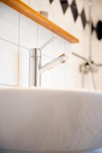 a sink in a bathroom with aaucet at Hotell Krabban in Strömstad