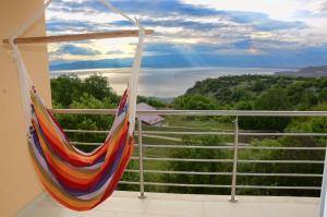 a hammock on a balcony with a view at Villa Velestovo in Ohrid