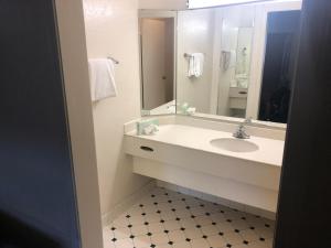 a bathroom with a sink and a mirror at Americas Best Value Inn Denver in Denver +20 photos
