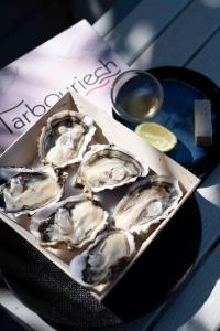 a box of oysters on a plate on a table at Le Spinaker in Le Grau-du-Roi