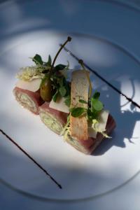 a white plate with a sandwich with cheese and greens at Le Spinaker in Le Grau-du-Roi