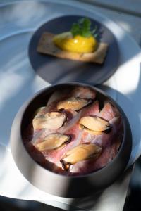 a bowl of food on a table with a plate of food at Le Spinaker in Le Grau-du-Roi