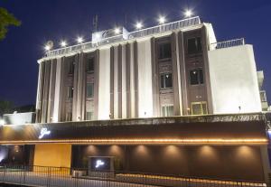 a large white building with lights on top of it at Hotel Gee (Adult Only) in Sakai