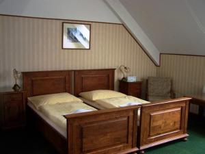 a bedroom with a large wooden bed in a room at Hotel Paříž in Jičín