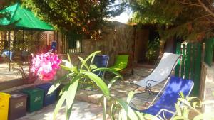 a group of chairs and a plant next to a fence at Baglio Del Sole in San Vito lo Capo