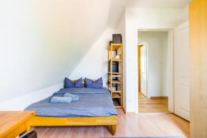a bedroom with a bed and a book shelf at Cosy Family Home in Tuningen