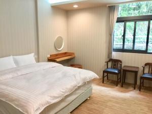 Postel nebo postele na pokoji v ubytování 微楓民宿 可加購晚餐酸白菜火鍋