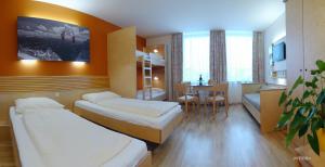 Postel nebo postele na pokoji v ubytování JUFA Hotel Grünau im Almtal