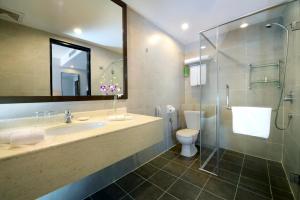 a bathroom with a sink and a toilet and a shower at Furama Bukit Bintang, Kuala Lumpur in Kuala Lumpur