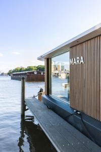 a building on the water next to a dock at Spreeapartment MARA in Berlin