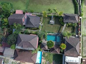 an overhead view of a house with roofs at Uma Caming Villas & Gym in Tegalalang