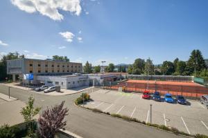 an empty parking lot in front of a building at Sport & Relax Hotel Davidek in Trutnov
