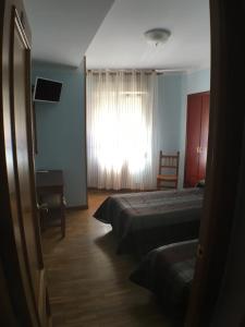Postel nebo postele na pokoji v ubytování Hostal ** EC León