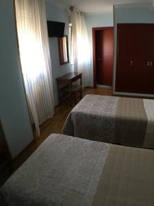 Postel nebo postele na pokoji v ubytování Hostal ** EC León