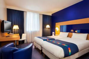
a hotel room with two beds and a television at Park Inn by Radisson Peterborough in Peterborough
