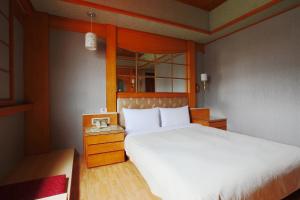 Postel nebo postele na pokoji v ubytování Hua Du Hotel