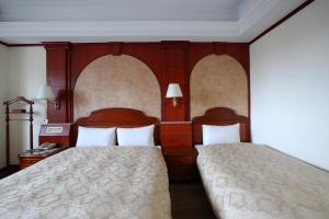 Postel nebo postele na pokoji v ubytování Hua Du Hotel