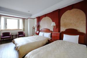 Postel nebo postele na pokoji v ubytování Hua Du Hotel