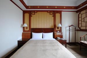 Postel nebo postele na pokoji v ubytování Hua Du Hotel