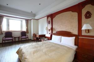 Postel nebo postele na pokoji v ubytování Hua Du Hotel