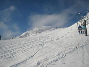 a ski lift going up a snow covered mountain at Hakuba Goryu Pension Kurumi in Hakuba