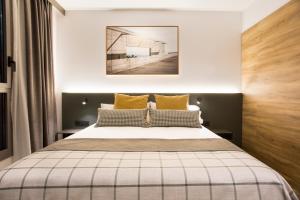 
a hotel room with a bed and two lamps at Acta Voraport in Barcelona
