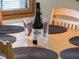a bottle of wine sitting on top of a table at Holiday Home Aida by Interhome in Tahkovuori