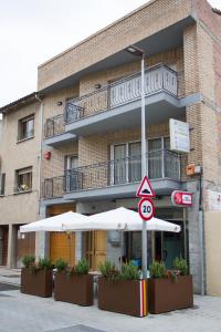 a building with an umbrella in front of it at hostal trevol in Torelló