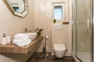 a bathroom with a sink and a toilet and a shower at Villa Rusula in Kastel Novi