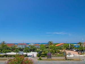 a view of a park with the ocean in the background at Apartment Sandra by Interhome in Le Focette