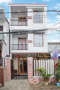 a white building with a sign in front of it at Lan Uyen Homestay - Hoi An in Hoi An