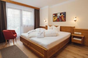 Postel nebo postele na pokoji v ubytování Hotel Garni am Sonnberg