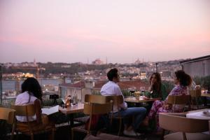 people sitting around a table at Georges Hotel Galata in Istanbul
