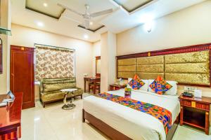 a bedroom with a bed and a desk and a chair at FabHotel Eleven Heights in Bhopal