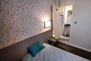 a bedroom with a large wall of white paper at Centre Jean Bosco in Lyon