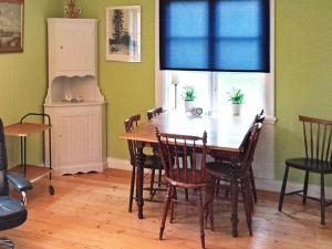 a dining room with a wooden table and chairs at 4 person holiday home in STUREFORS in Sturefors