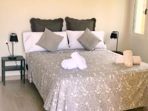 una camera da letto con un letto e due asciugamani di Apartamentos Lunamar a El Campello