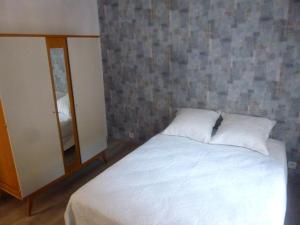 a bedroom with a white bed and a mirror at Gite de la plage in Mers-les-Bains