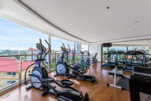 a gym with treadmills and elliptical machines at Nova Suites Pattaya by Compass Hospitality in Pattaya