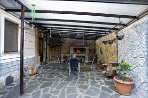 a patio with a table and chairs and a fireplace at SunnyAvlabari Homestay in Tbilisi City