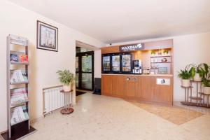 a lobby of a pharmacy with potted plants at Maxima Slavia Hotel in Moscow