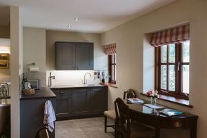 a kitchen with a table and a dining room at The Apple Rooms - Houghton Lodge in Stockbridge