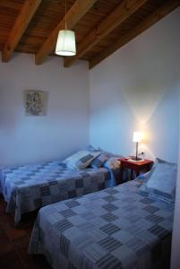 Łóżko lub łóżka w pokoju w obiekcie Casa Rural La Torre