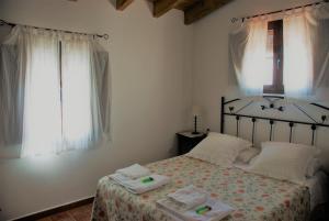 Łóżko lub łóżka w pokoju w obiekcie Casa Rural La Torre