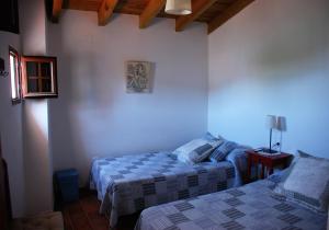 Łóżko lub łóżka w pokoju w obiekcie Casa Rural La Torre