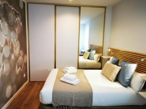 ein Schlafzimmer mit einem großen Bett mit Handtüchern darauf in der Unterkunft VTZ El Balcón de Torre Nueva III in Saragossa
