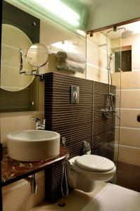 a bathroom with a sink and a toilet at Hotel Niharika in Kolkata