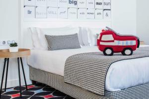 a bedroom with a bed with a red toy truck on it at Hotel Joke - Astotel in Paris