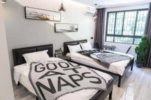 Voodi või voodid majutusasutuse Xiamen Guiran Hostel toas